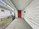 The porch showing a red front door, white siding, and a concrete walkway with greenery nearby at 1819 Southeastern Ave, Indianapolis, IN 46201