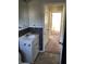 Bathroom with vanity, view of hallway, and dark tile at 1900 E 24Th St, Muncie, IN 47302