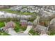 An aerial view of a neighborhood with a pond, mature trees, and well-maintained lawns at 20485 Country Pine Ct, Noblesville, IN 46062