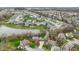 An aerial view of a neighborhood with a pond, mature trees, and well-maintained lawns at 20485 Country Pine Ct, Noblesville, IN 46062