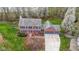 An aerial view of a two-story brick home with a three-car garage and mature trees at 20485 Country Pine Ct, Noblesville, IN 46062