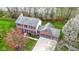 An aerial view of a two-story brick home with a three-car garage and mature trees at 20485 Country Pine Ct, Noblesville, IN 46062