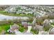 An aerial view of a neighborhood with a pond, mature trees, and well-maintained lawns at 20485 Country Pine Ct, Noblesville, IN 46062