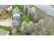 Aerial view showcases a home and flowering trees, offering a picturesque setting near water at 20485 Country Pine Ct, Noblesville, IN 46062