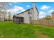 Charming backyard featuring a screened porch, tall chimney, and lush green grass with a wooden fence at 20485 Country Pine Ct, Noblesville, IN 46062