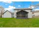 View of a home's backyard with a screened-in porch and well-maintained lawn at 20485 Country Pine Ct, Noblesville, IN 46062