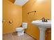 Small bathroom with pedestal sink and orange walls at 20485 Country Pine Ct, Noblesville, IN 46062
