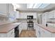 Bright kitchen featuring white cabinets, laminate countertop and stainless steel appliances at 20485 Country Pine Ct, Noblesville, IN 46062