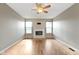 Living room with hardwood floors, fireplace, and ceiling fan at 20485 Country Pine Ct, Noblesville, IN 46062