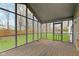Screened porch features weathered floors and serene backyard views, perfect for relaxing outdoors at 20485 Country Pine Ct, Noblesville, IN 46062