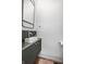 Stylish powder room with a dark green vanity and floating sink at 220 N Beville Ave, Indianapolis, IN 46201