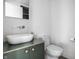 Modern bathroom with white sink and green vanity at 220 N Beville Ave, Indianapolis, IN 46201