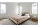 Spacious bedroom with large windows, light walls, and a wooden bed frame at 220 N Beville Ave, Indianapolis, IN 46201