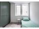 Small basement bedroom with green closet and single bed at 220 N Beville Ave, Indianapolis, IN 46201