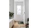 Bright and airy entryway with cork flooring, built-in storage, and a view to the backyard at 220 N Beville Ave, Indianapolis, IN 46201