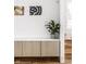 Modern entryway with built-in storage, cork flooring, and artwork at 220 N Beville Ave, Indianapolis, IN 46201