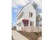 Charming two-story home with white siding, contrasting trim, pink door, and a cute picket fence at 220 N Beville Ave, Indianapolis, IN 46201