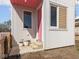 Modern home featuring corrugated metal siding, pink door and accents, and charming flower pots at 220 N Beville Ave, Indianapolis, IN 46201