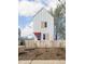 Charming two-story home with white siding, contrasting trim, pink door, and a cute picket fence at 220 N Beville Ave, Indianapolis, IN 46201