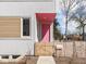 Close up of a front door painted in bright pink with picket fence in yard at 220 N Beville Ave, Indianapolis, IN 46201