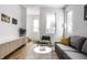 Modern living room with gray sofa and large windows at 220 N Beville Ave, Indianapolis, IN 46201