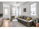 Cozy living room featuring a gray sofa and natural light at 220 N Beville Ave, Indianapolis, IN 46201