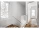 Bright upstairs hallway with white walls and cork flooring at 220 N Beville Ave, Indianapolis, IN 46201
