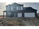 Two-story home with dark brick and vinyl siding, two-car garage, and covered porch at 241 Ames Dr, Whiteland, IN 46184