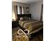 Bedroom with a dark brown bed frame and patterned bedding at 2714 Baltimore Ave, Indianapolis, IN 46218