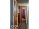 Long hallway with doors leading to bedrooms and a bathroom at 3915 Brookville Rd, Indianapolis, IN 46201