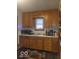 Classic kitchen with wood cabinets and modern appliances at 3915 Brookville Rd, Indianapolis, IN 46201
