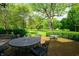 Outdoor patio with mature trees, brick pavers, and outdoor seating, perfect for entertaining at 4601 N Legacy Dr, Muncie, IN 47304