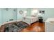 Light and airy bedroom featuring hardwood floors, large windows, and a cozy rug at 4601 N Legacy Dr, Muncie, IN 47304