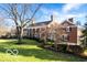 Brick colonial home with manicured lawn and mature trees at 4601 N Legacy Dr, Muncie, IN 47304