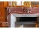 Ornate fireplace mantel with carved details and gold accents at 4601 N Legacy Dr, Muncie, IN 47304