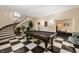 Basement game room with a pool table, spiral staircase, and tiled checkerboard floor at 4601 N Legacy Dr, Muncie, IN 47304