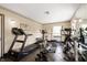 Well-equipped home gym with treadmill, exercise bike, weight machines and mirror at 4601 N Legacy Dr, Muncie, IN 47304