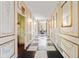 Elegant hallway with checkered floors, decorative walls, and ornate lighting, leading to a formal dining room at 4601 N Legacy Dr, Muncie, IN 47304