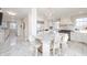 Bright, modern kitchen with marble floors, a center island with seating, and stainless steel appliances at 4601 N Legacy Dr, Muncie, IN 47304