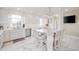 Modern kitchen with marble floors, white cabinets, stainless steel appliances, and a center island with seating at 4601 N Legacy Dr, Muncie, IN 47304