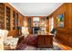 Spacious library with built-in bookshelves and a wood-paneled fireplace at 4601 N Legacy Dr, Muncie, IN 47304