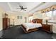 Spacious main bedroom with ceiling fan, ample natural light, and elegant dark wood furniture at 4601 N Legacy Dr, Muncie, IN 47304