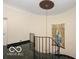 Elegant curved staircase with black marble flooring and wrought iron railing at 4601 N Legacy Dr, Muncie, IN 47304