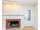 Living room with brick fireplace and wood floors at 4621 E 37Th St, Indianapolis, IN 46218