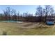 Picturesque pond with mature trees and a rustic storage shed in a serene backyard setting at 5682 N Michigan Rd, Fairland, IN 46126