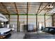 Inside view of a metal barn with white walls, wood ceiling beams, and lots of space at 5682 N Michigan Rd, Fairland, IN 46126