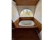 Bathroom featuring soaking tub and arched window with natural light at 5682 N Michigan Rd, Fairland, IN 46126