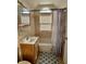 Compact bathroom featuring a vanity, bathtub with a shower, and a window for natural light at 5682 N Michigan Rd, Fairland, IN 46126