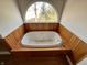 Bathroom featuring soaking tub and arched window with scenic view at 5682 N Michigan Rd, Fairland, IN 46126