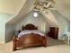 Spacious bedroom with vaulted ceiling, ceiling fan, and round window at 5682 N Michigan Rd, Fairland, IN 46126